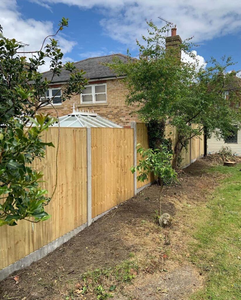 This is a photo of fence panels installed in a residential garden using concrete posts and gravel boards. Installed by Fast Fix Fencing Brandon